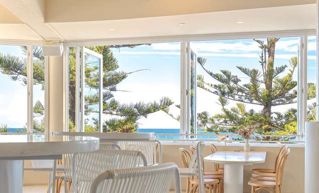 inside Dune by Pavilion with wide windows overlooking the beach