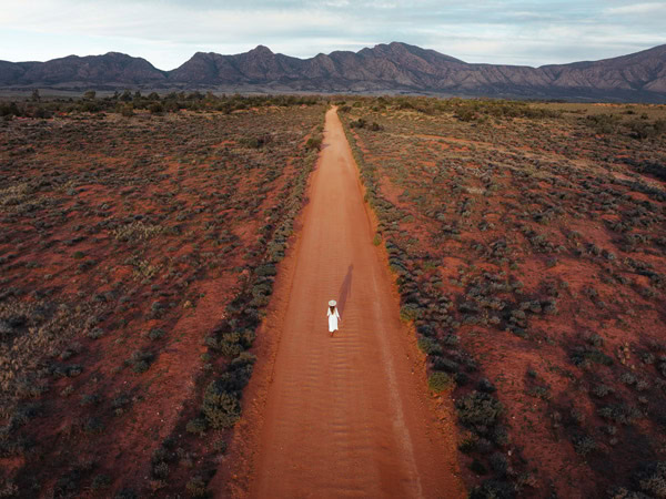 a woman standing in the middle of the desert plains in Flinders Ranges