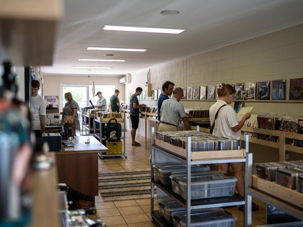 people browsing vinyls inside Air Raid Records, Woolner NT