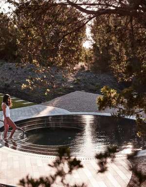 woman getting into a pool at Alba Thermal Springs
