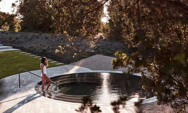 woman getting into a pool at Alba Thermal Springs