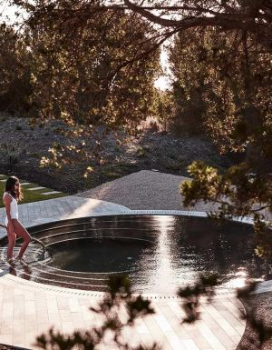woman getting into a pool at Alba Thermal Springs