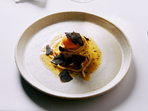 a plate of pasta at Al Dente Enoteca