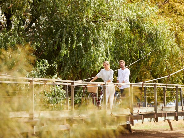 Couple cycling by the Belubula River near Orange