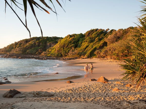 walking hand in hand along the Coolum Beach, Sunshine Coast