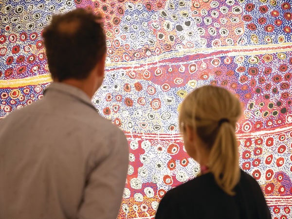a couple looking at a painting in Desert Mob