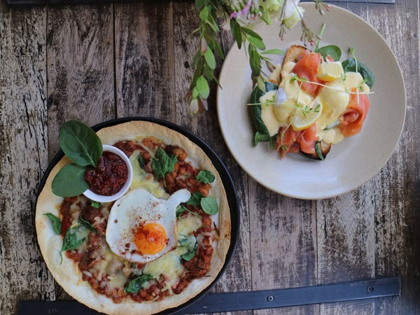 two plates of food on the table at Epilogue Lounge & Rooftop Bar
