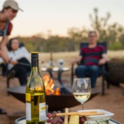 Family around the campfire at Squeaky Windmill near Alice Springs