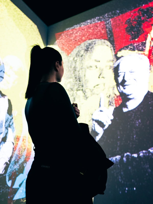 a woman admiring the exhibition dedicated to Mushroom Records