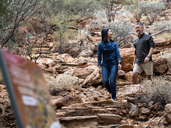 a couple exploring the Olive Pink Botanic Garden
