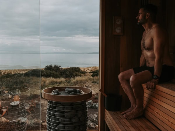 a man sitting in a sauna at Still at Freycinet, Coles Bay, Tas