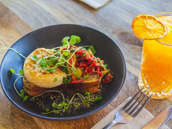 a dish and cocktail drink on the table at The Locals