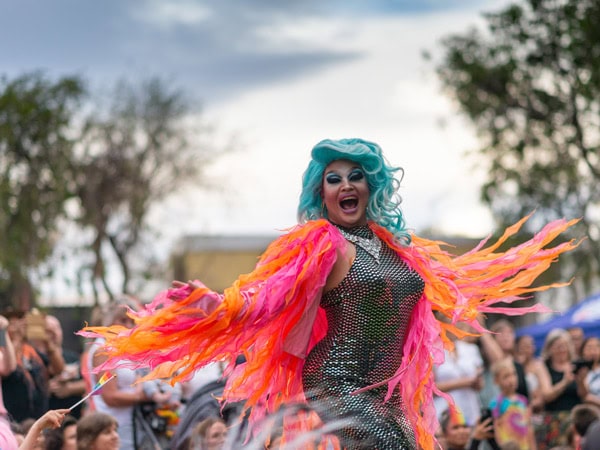 a performer at FabALICE Festival dressed in vibrant costume