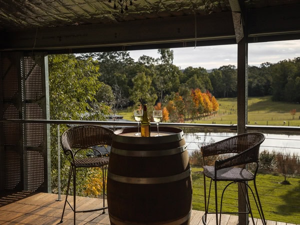 two chairs facing a wine barrel table at Little Valley Farm