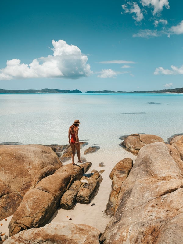 a person standing on a beach rock at Hill Inlet