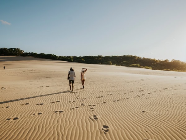 a couple walking on Carlo Sandblow
