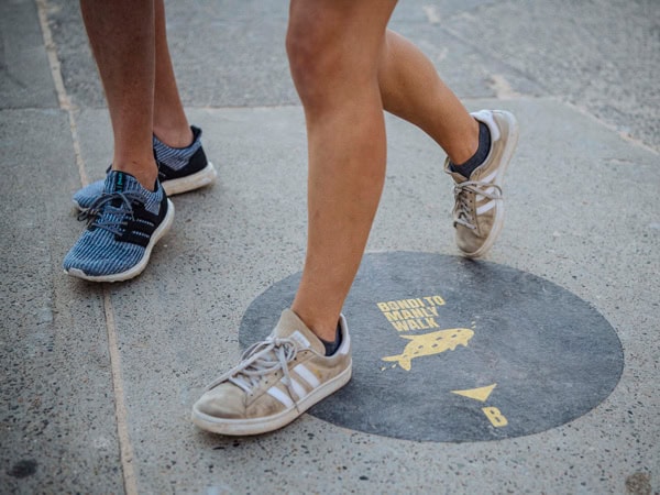 feet running across the Bondi to Manly Coastal Walk symbol from Bondi Beach