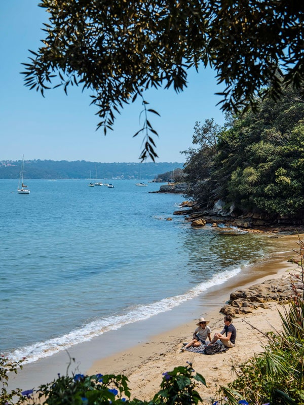 a couple enjoying a picnic on the beach, Bondi to Manly coastal walk