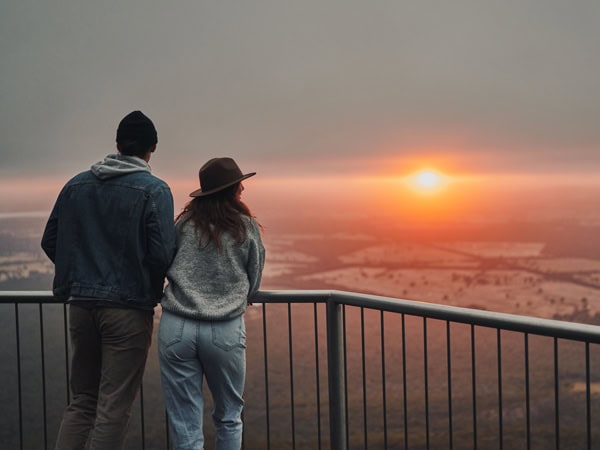 a couple admiring the sunrise from Boroka Lookout in Grampians National Park, Vic