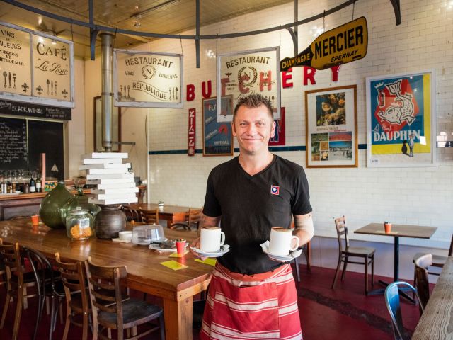 waiter holding coffe inside Butcher Shop Cafe Mudgee