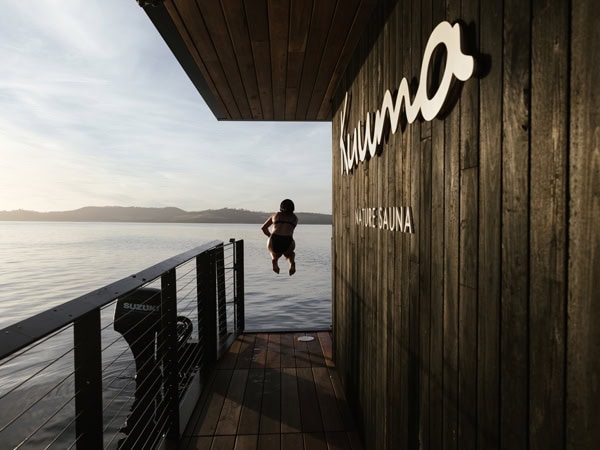 Person jumping from Kuuma Nature Sauna at sunrise