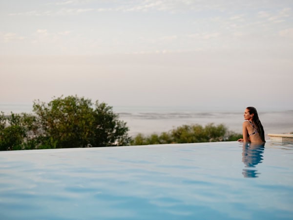 a woman relaxing in the infinity pool at Eco Beach Resort, WA