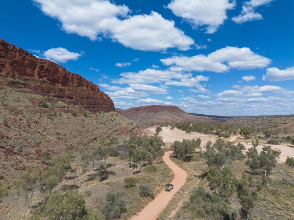 a vehicle driving across Finke Gorge National Park