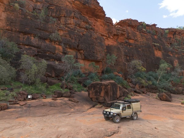 a 4WD driving across Finke Gorge