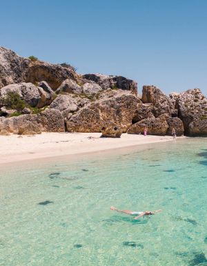 the white-sand shoreline and crystal clear waters of Stokes Bay