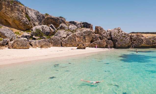 the white-sand shoreline and crystal clear waters of Stokes Bay