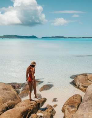 a person standing on a beach rock at Hill Inlet