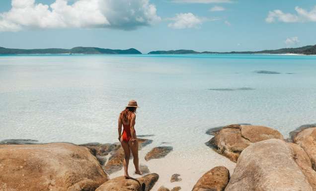 a person standing on a beach rock at Hill Inlet