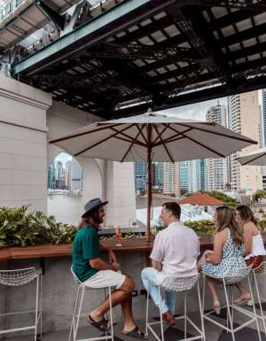 friends dining at Fiume Bar with views of the Story Bridge