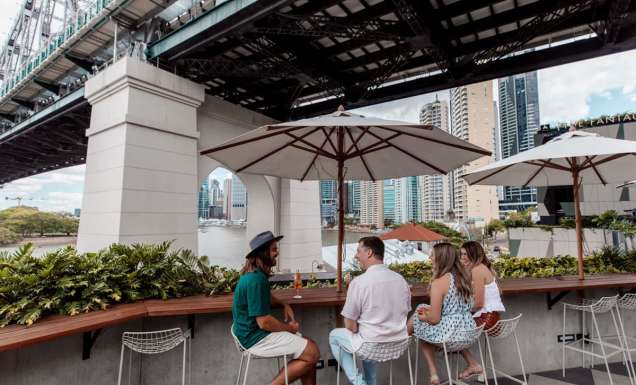 friends dining at Fiume Bar with views of the Story Bridge