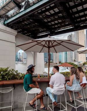 friends dining at Fiume Bar with views of the Story Bridge