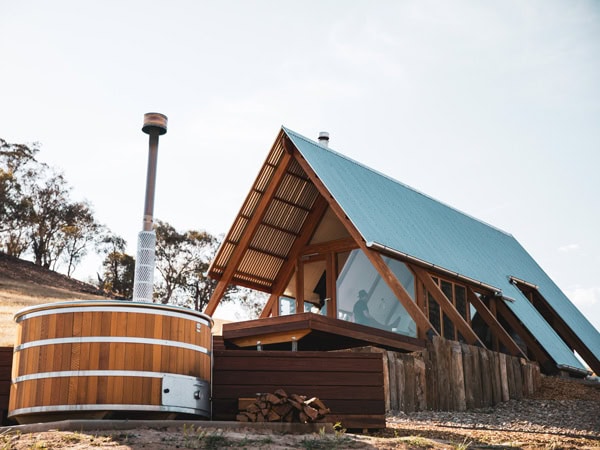 an A-frame eco hut at Kimo Estate with a woodfired hot tub