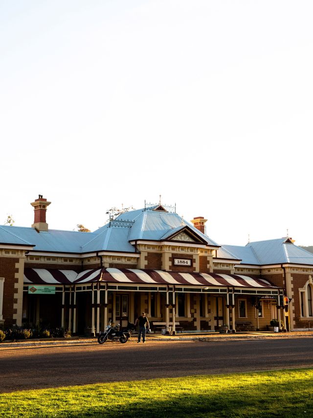 man on bike in front of historic building in mudgee
