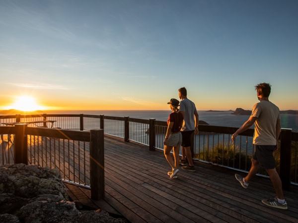 a group walking along the pathway at sunrise Passage Peak on Hamilton Island, Qld