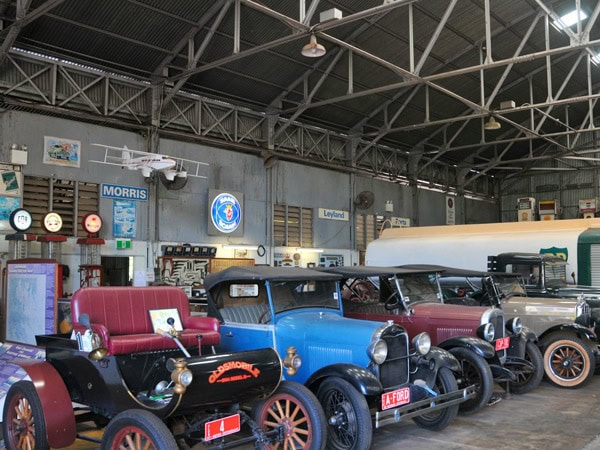 old vehicles on display inside Qantas Guinea Airways Hangar, NT