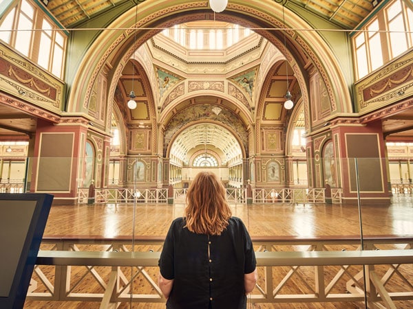 a woman standing inside Royal Exhibition Building Dome Promenade, Vic