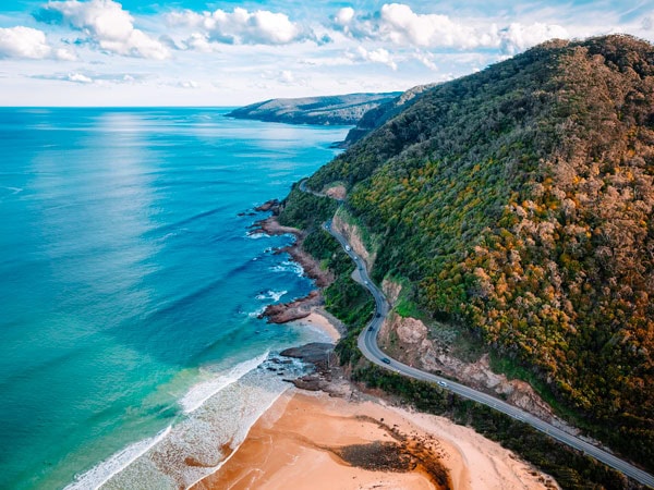 an aerial view of the beach by the Great Ocean Road