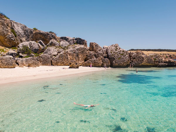 the white-sand shoreline and crystal clear waters of Stokes Bay