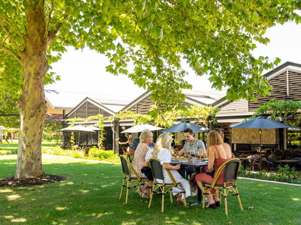 a group of friends sampling wines in an outdoor garden setting at Sandalford Wines, Swan Valley