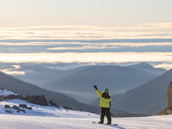 a skier at the top of Australia's Highest Lifted Point in Thredbo during sunrise