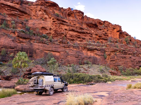a 4WD driving across Finke Gorge