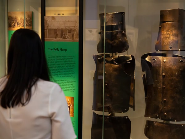 a woman looking at Ned Kelly's iconic armours on display at the Victoria Police Museum, Vic