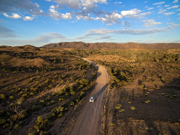an aerial view of a vehicle driving through Vulkathunha-Gammon Ranges National Park