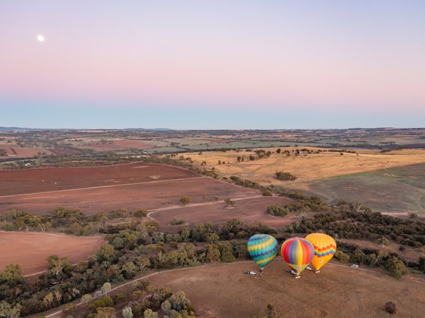 an aerial view of hot air balloons surrounding Avon Valley