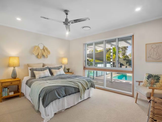 a bedroom with pool view at La Vida Airbnb, Mooloolaba