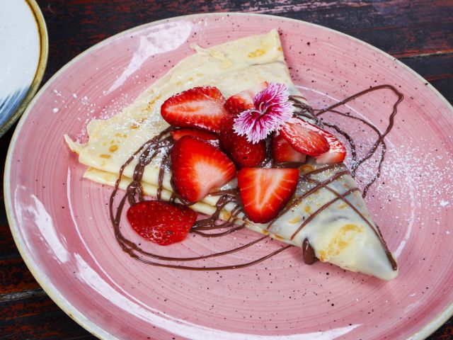 a plate of strawberry crepe at The Velo Project, Mooloolaba